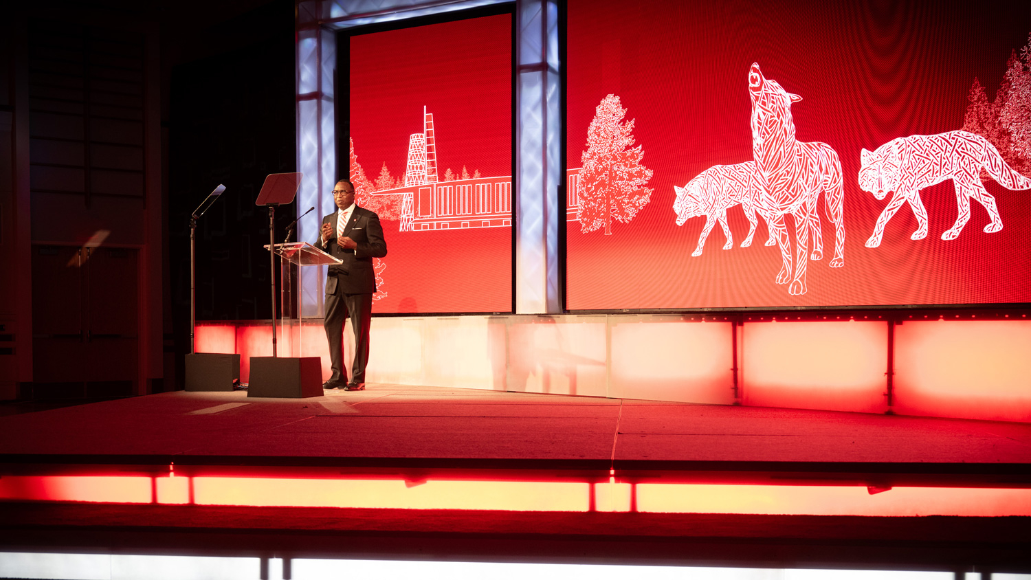 Chancellor Kevin Howell standing at the lectern on the 2026 NC State Honors stage.